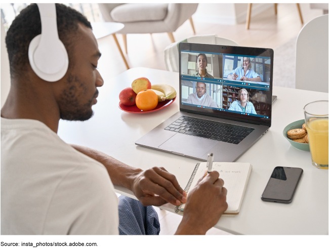 Man sitting at a desk working on a laptop