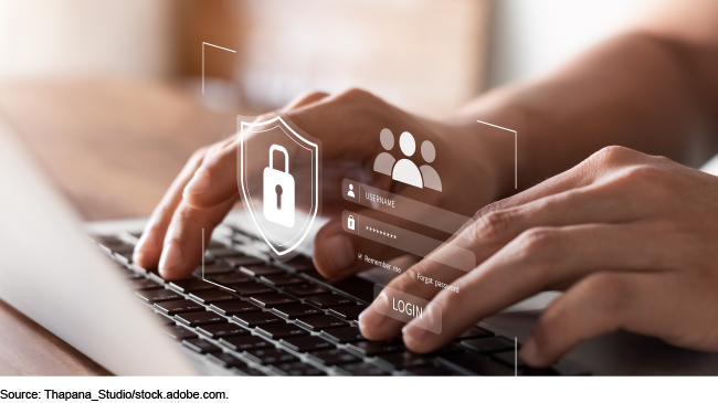 hands typing on a laptop keyboard with a login screen graphic superimposed over the hands