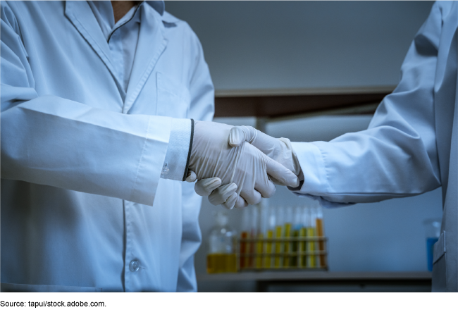 Scientists shaking hands. 