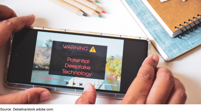 Phone giving warning of deepfake technology.