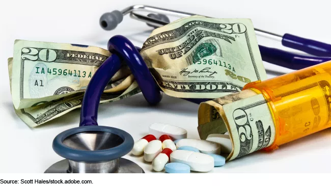 Stock image showing medication, a stethoscope and $20s --illustrating health care costs.