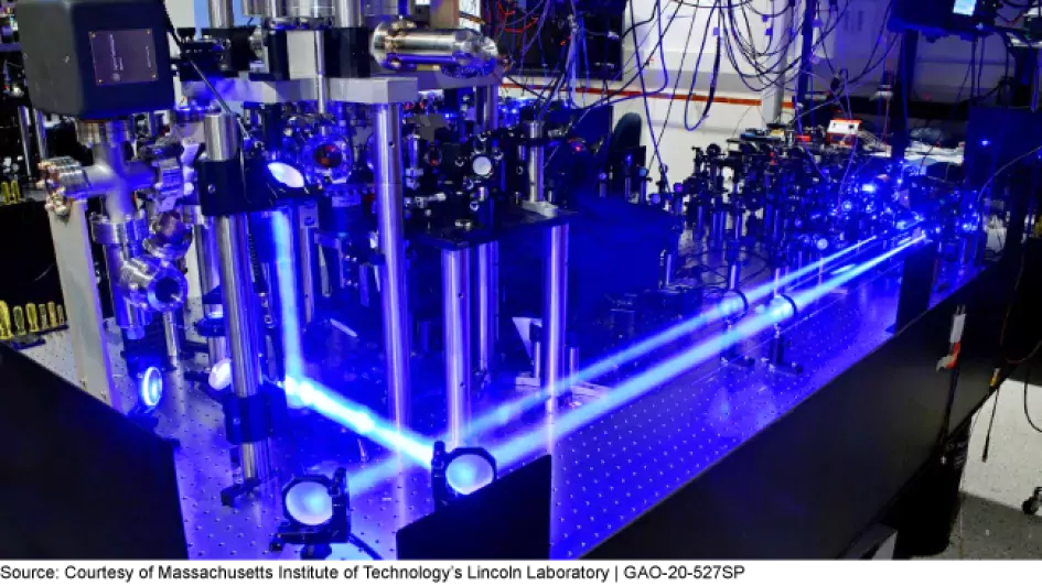 The image shows a trapped ion qubit (a quantum bit) test bed in the Quantum Information and Integrated Nanosystems Group at Lincoln Laboratory.