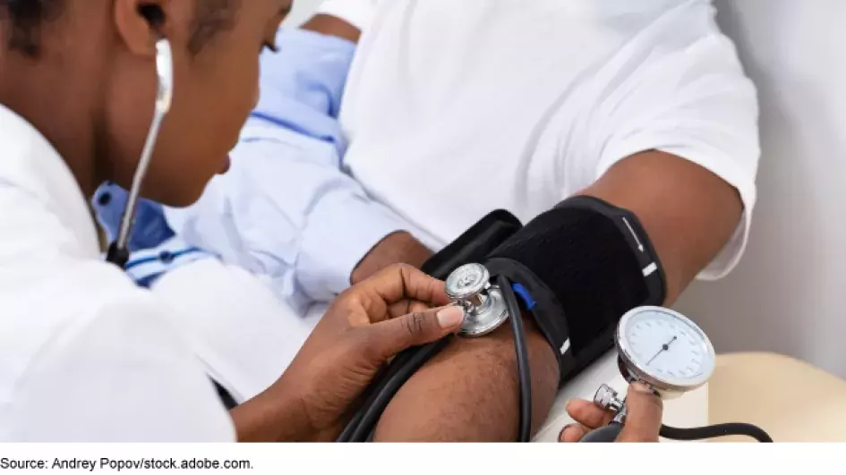 Doctor taking patients blood pressure 