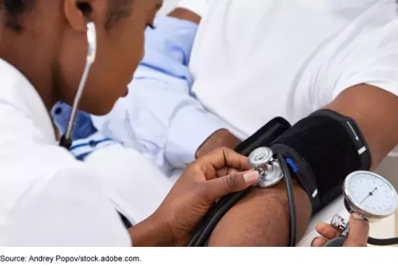 Doctor taking patients blood pressure