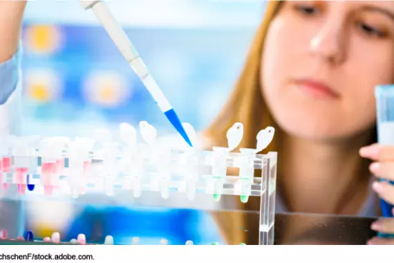 Photo showing a woman filling medical test tubes using a droplet syringe